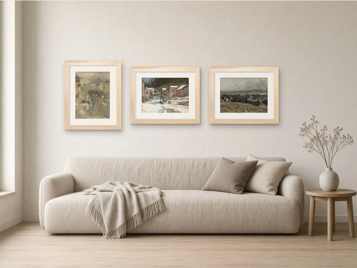Snow & Moving Water gallery wall, Light Wood frames, in a living room